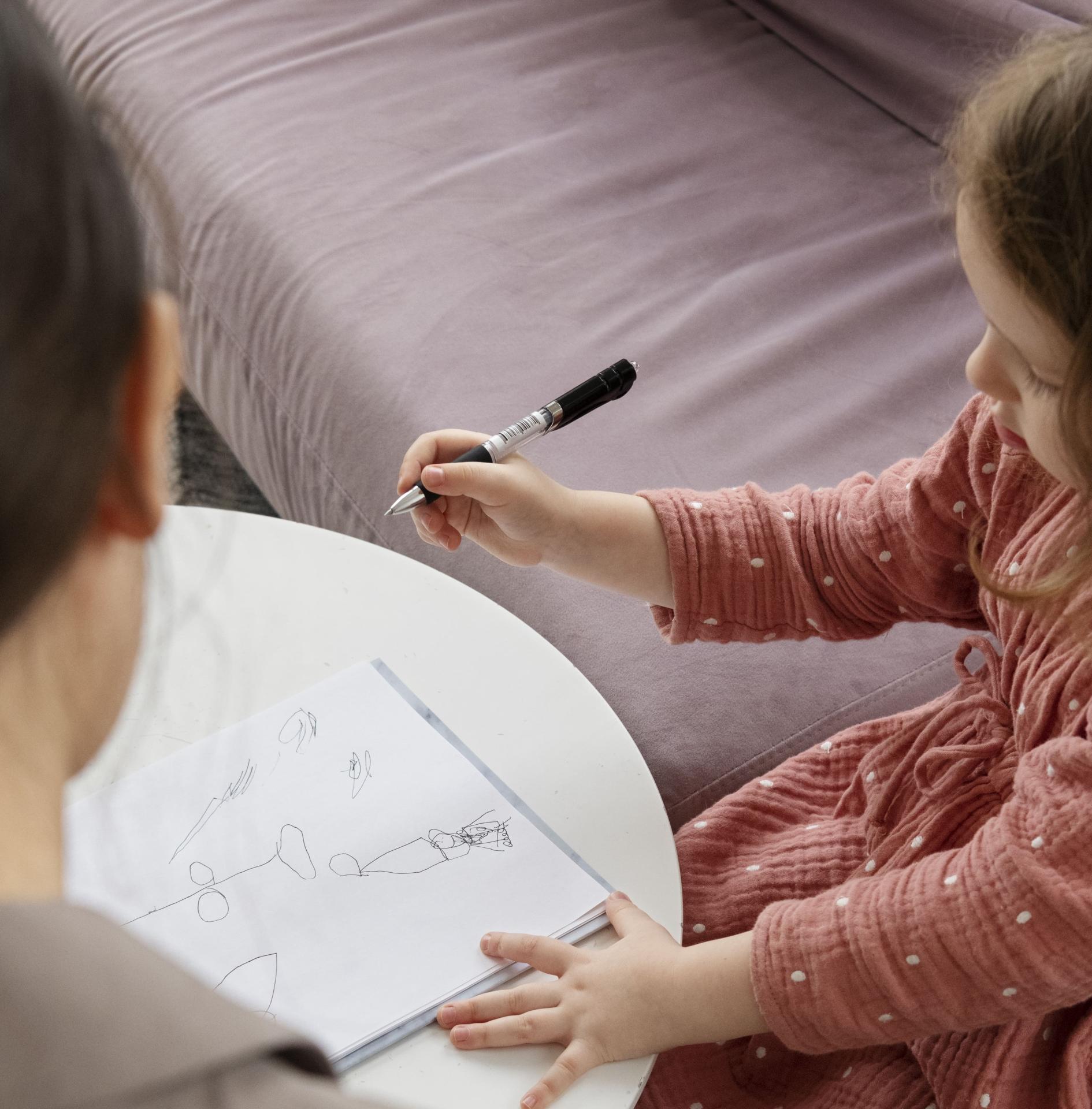 Child doing therapy session with psychologist 2