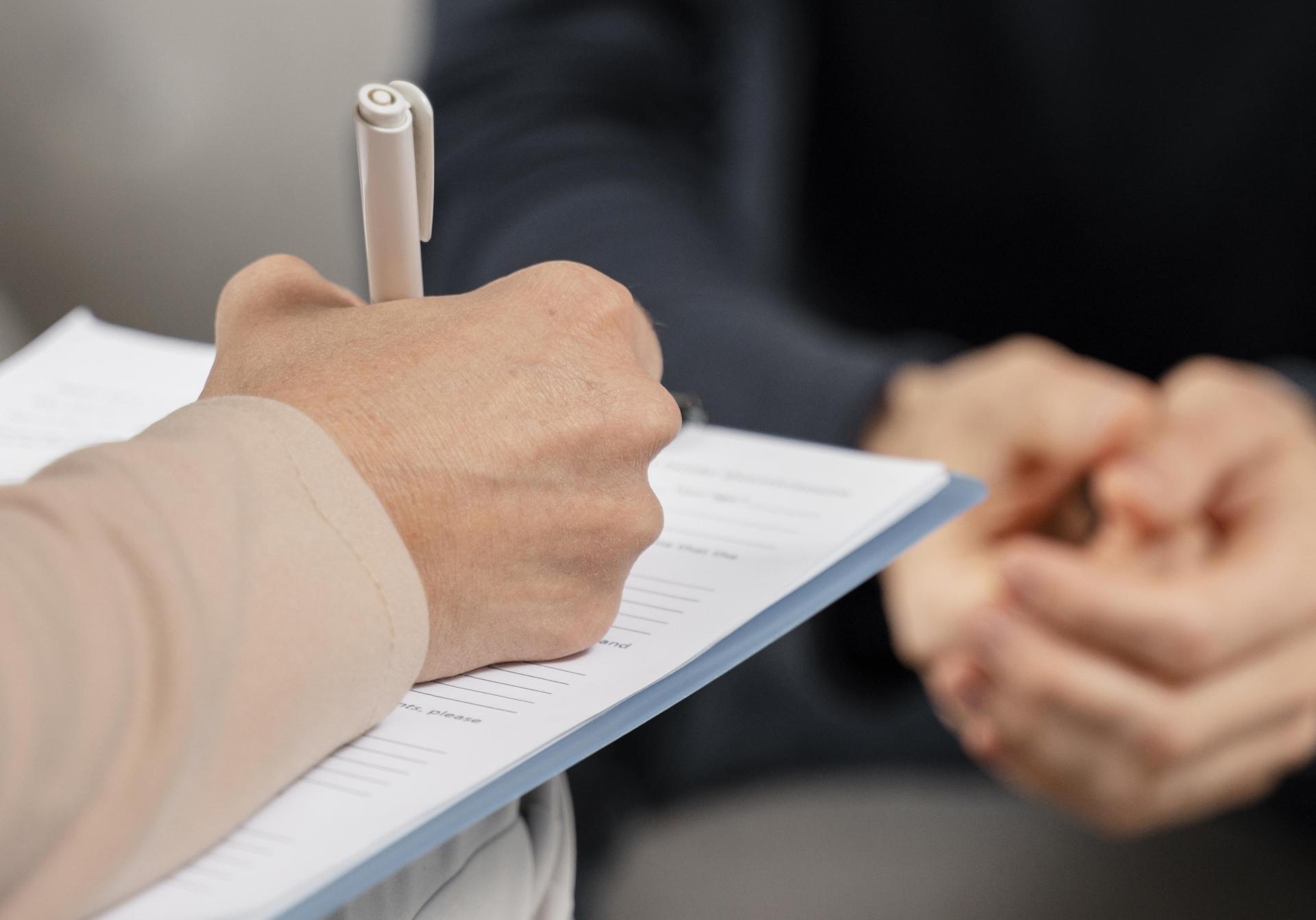 Mid shot woman therapist taking notes clipboard